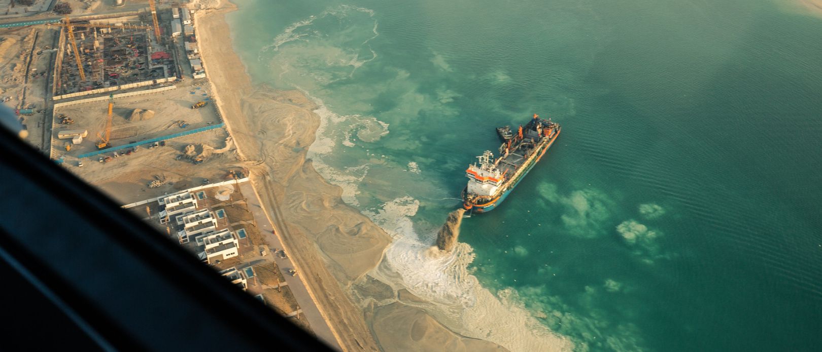 Sand dredging ship working on Palm Jumeirah in Dubai